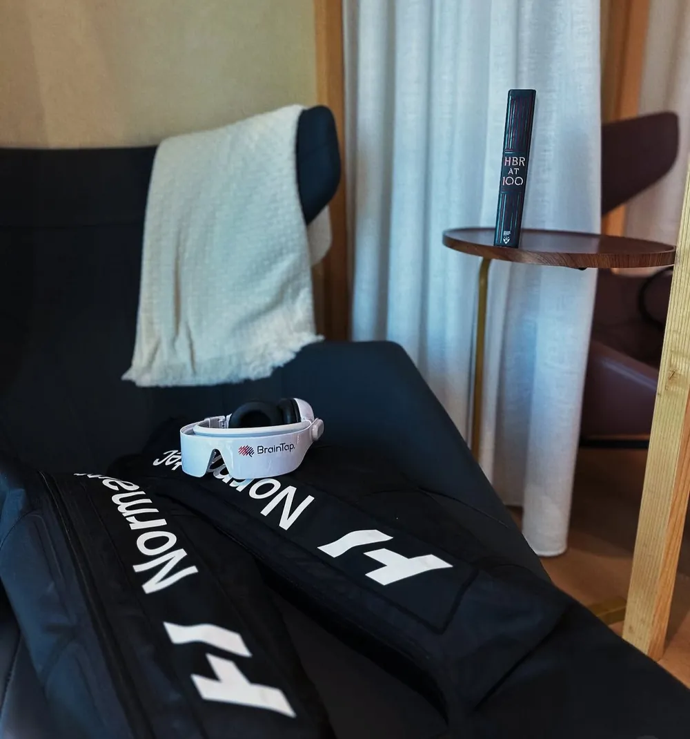 Compression boots and a BrainTap headset set up in the recovery lounge